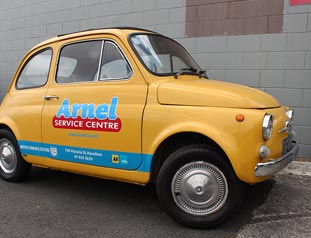 Yellow car with logo reading Arnel service centre