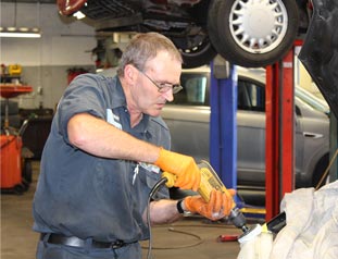 Car mechanic performing a vehicle repair