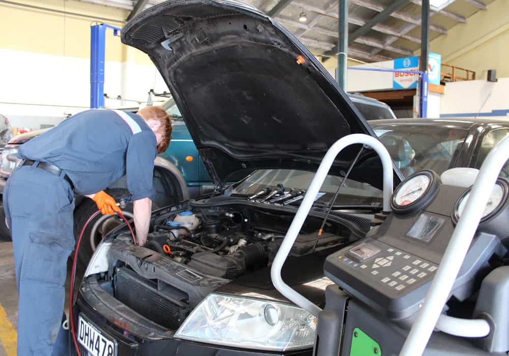 Diagnostics equipment used by a young mechanic during a car service