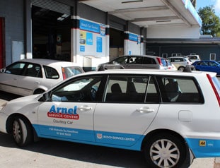 White car with Arnel service centre logo on door