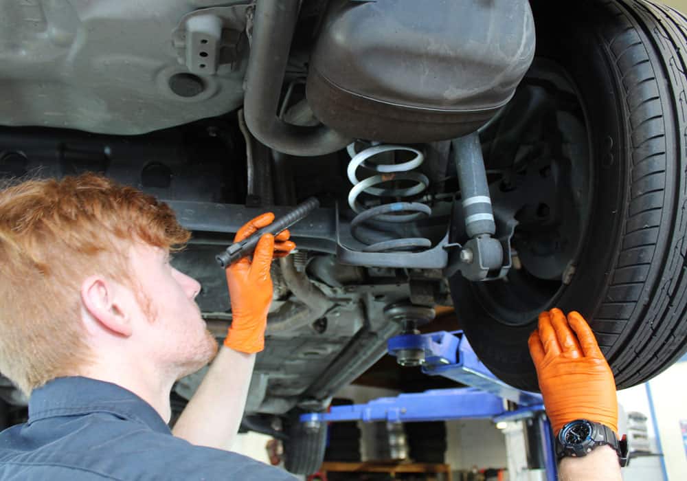 Car mechanic performing a WOF check in Hamilton