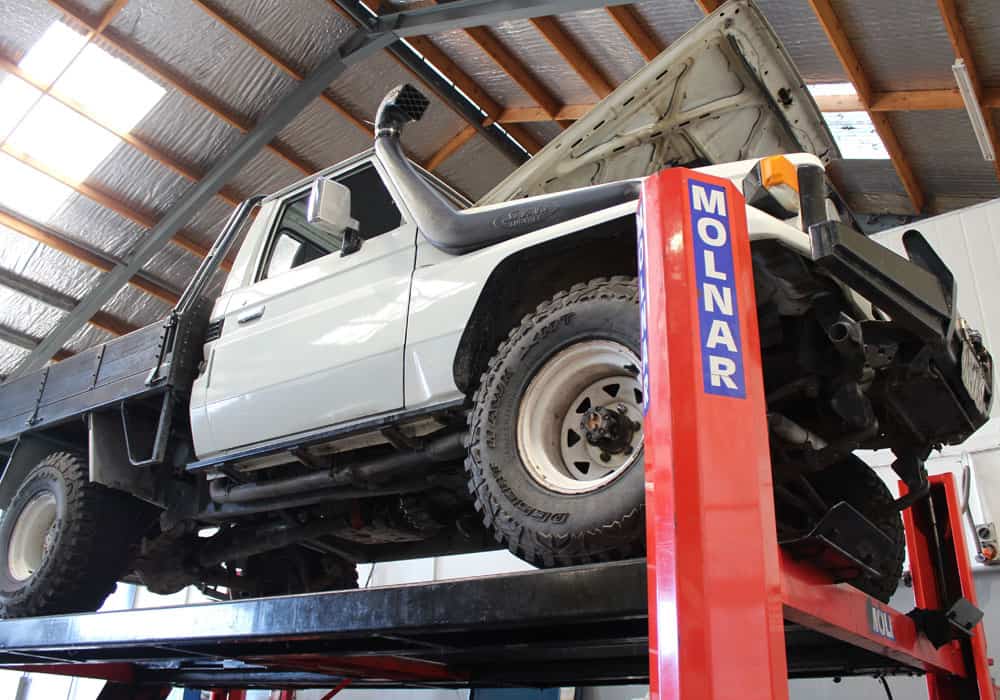 Car with hood raised for auto repairs in Hamilton