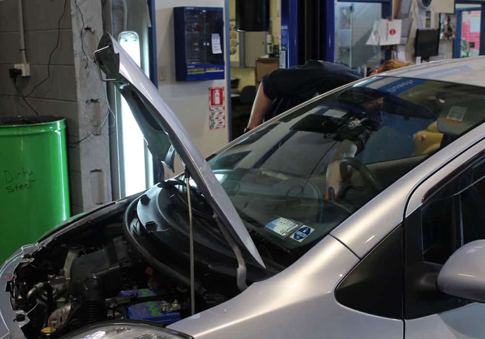 Car with hood raised for auto repairs in Hamilton